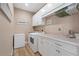 Well-equipped laundry room featuring modern appliances and ample storage at 2850 Magdalina Dr, Punta Gorda, FL 33950