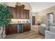 Entertaining area featuring custom cabinets, a wine fridge, and views into the formal living room at 2850 Magdalina Dr, Punta Gorda, FL 33950