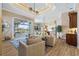 Open-concept living room with tile flooring, a tray ceiling, and access to the outdoor living space at 2850 Magdalina Dr, Punta Gorda, FL 33950