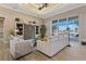 Bright living room showcasing tray ceilings, neutral tones, stylish furniture, and sliding glass doors with water views at 2850 Magdalina Dr, Punta Gorda, FL 33950