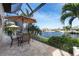 Serene screened-in patio featuring a dining area with beautiful waterfront views at 2850 Magdalina Dr, Punta Gorda, FL 33950