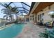 Resort-style pool area with a screened lanai, outdoor kitchen, and stunning water views at 2850 Magdalina Dr, Punta Gorda, FL 33950