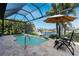 Gorgeous backyard with a screened-in pool, lush landscaping, and peaceful canal views at 2850 Magdalina Dr, Punta Gorda, FL 33950