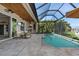 Inviting screened-in lanai with swimming pool and outdoor kitchen with water view at 2850 Magdalina Dr, Punta Gorda, FL 33950