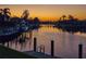 Sunset view of boats docked at a private pier in a waterfront community at 2850 Magdalina Dr, Punta Gorda, FL 33950