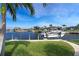 A private boat lift on a canal provides direct access to waterfront living with lush landscaping and bright skies overhead at 2850 Magdalina Dr, Punta Gorda, FL 33950