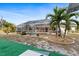 Screened-in pool and tropical landscaping surrounded by artificial turf and tropical greenery at 3078 Mancini Ter, Punta Gorda, FL 33983