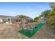 Expansive backyard with screened-in pool, tropical landscaping, and outdoor games at 3078 Mancini Ter, Punta Gorda, FL 33983