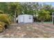 Backyard Shed with outdoor grill and tropical landscaping, offering practical and aesthetic value at 3078 Mancini Ter, Punta Gorda, FL 33983