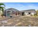 Wide backyard with pool, patio, and lush landscape, perfect for outdoor relaxation and entertainment at 3078 Mancini Ter, Punta Gorda, FL 33983