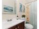 Bathroom featuring a single sink vanity, shower and decorative artwork at 3078 Mancini Ter, Punta Gorda, FL 33983