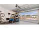 Garage with natural light, golf cart, and plenty of room for parking and hobbies at 3078 Mancini Ter, Punta Gorda, FL 33983