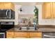 Kitchen sink featuring stainless steel appliances and view to lanai at 3078 Mancini Ter, Punta Gorda, FL 33983