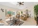 Cozy living room featuring tile floors and sliding glass doors to the lanai and pool area at 3078 Mancini Ter, Punta Gorda, FL 33983