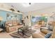 Relaxing living room showcasing a view of the screened-in lanai and pool area at 3078 Mancini Ter, Punta Gorda, FL 33983