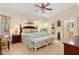 Spacious main bedroom featuring decorative headboard, bench and tiled flooring at 3078 Mancini Ter, Punta Gorda, FL 33983