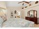 Comfortable main bedroom with ceiling fan, decor, and adjoining bathroom at 3078 Mancini Ter, Punta Gorda, FL 33983