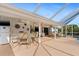 Large covered patio with dining area, fridge, and multiple seating areas perfect for outdoor living at 3078 Mancini Ter, Punta Gorda, FL 33983