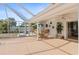 Spacious screened-in patio with outdoor dining area and ceiling fans for comfortable entertaining at 3078 Mancini Ter, Punta Gorda, FL 33983
