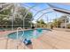 Serene screened pool with a lush backdrop, offering a private outdoor oasis at 3078 Mancini Ter, Punta Gorda, FL 33983