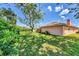 Expansive backyard featuring lush green grass, mature trees, and privacy-enhancing landscaping at 3287 Meadow Run Cir, Venice, FL 34293