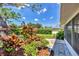 Manicured backyard featuring vibrant plants, trees, and garden at 3287 Meadow Run Cir, Venice, FL 34293