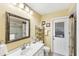 Bright bathroom with walk-in shower, large mirror, and outdoor access at 3287 Meadow Run Cir, Venice, FL 34293