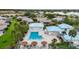 Aerial view of community pool, with umbrellas and lounge chairs, near the recreation center at 3287 Meadow Run Cir, Venice, FL 34293