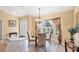 Cozy dining area with a round table, chandelier, and view of the outdoors at 3287 Meadow Run Cir, Venice, FL 34293