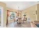 Cozy dining area with a round table, chandelier, and view of the outdoors at 3287 Meadow Run Cir, Venice, FL 34293