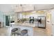 Modern kitchen with stainless steel appliances, granite countertops, and breakfast bar at 3287 Meadow Run Cir, Venice, FL 34293