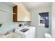 Functional laundry room with updated washer and dryer and convenient storage at 3287 Meadow Run Cir, Venice, FL 34293