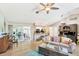 Open living area with a piano, cozy seating, and views of the back patio at 3287 Meadow Run Cir, Venice, FL 34293