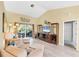 Bright living room with hardwood floors and a cozy seating area at 3287 Meadow Run Cir, Venice, FL 34293