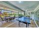 Inviting sunroom with dining and game areas, great for entertaining or relaxing at 3287 Meadow Run Cir, Venice, FL 34293