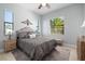 Bright bedroom with a decorative welcome pillow, ceiling fan, and natural light from large windows at 347 Portofino Dr, Punta Gorda, FL 33950