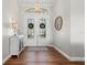 Inviting foyer with a decorative cabinet, beautiful double doors, and wood-look floors at 347 Portofino Dr, Punta Gorda, FL 33950
