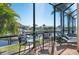 Screened lanai has relaxing seating area with views of the canal and surrounding landscape at 347 Portofino Dr, Punta Gorda, FL 33950