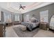Spacious main bedroom featuring tray ceilings, sitting area, and ensuite bathroom at 347 Portofino Dr, Punta Gorda, FL 33950