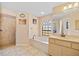 Bathroom features a tub, shower, tiled floors, and vanity with a mirror at 3614 January Ave, North Port, FL 34288