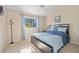 A cozy bedroom featuring natural light and a comfortable queen-size bed at 3614 January Ave, North Port, FL 34288
