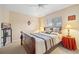 Bedroom with an upholstered bed and a window, complemented by bedside tables and lamps at 3614 January Ave, North Port, FL 34288