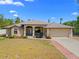 Charming single-story home with a well-maintained lawn, attached two car garage, and neutral color palette at 3614 January Ave, North Port, FL 34288