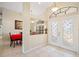 Bright foyer with high ceilings, decorative windows, tile flooring, and view into the dining area at 3614 January Ave, North Port, FL 34288