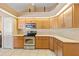 Well-lit kitchen features stainless steel oven and microwave, light wood cabinets, and tile flooring at 3614 January Ave, North Port, FL 34288