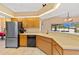 Bright kitchen features stainless steel refrigerator, tile flooring, and plenty of counter space at 3614 January Ave, North Port, FL 34288