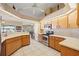Well-lit kitchen with light wood cabinets, stainless steel appliances, and tile flooring at 3614 January Ave, North Port, FL 34288
