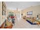 Open living space with tile flooring, neutral decor, and view into the dining area and front entry at 3614 January Ave, North Port, FL 34288