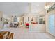 Open-concept living area with tile flooring, neutral walls, and view into the dining room and kitchen at 3614 January Ave, North Port, FL 34288