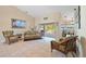 Bright living area with tile flooring, vaulted ceilings, comfortable seating, and view of the lanai at 3614 January Ave, North Port, FL 34288